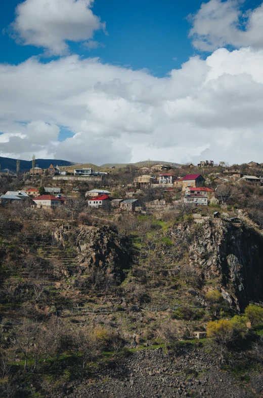 a large city sits atop the edge of a mountain