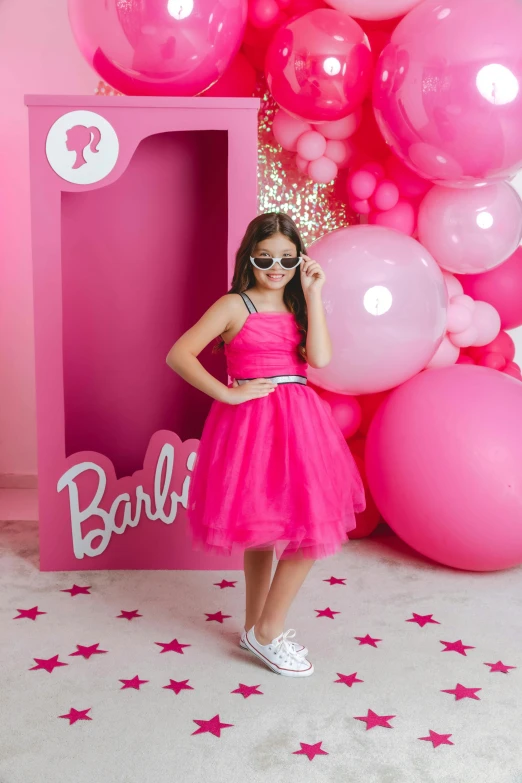 a girl posing with balloons at an event