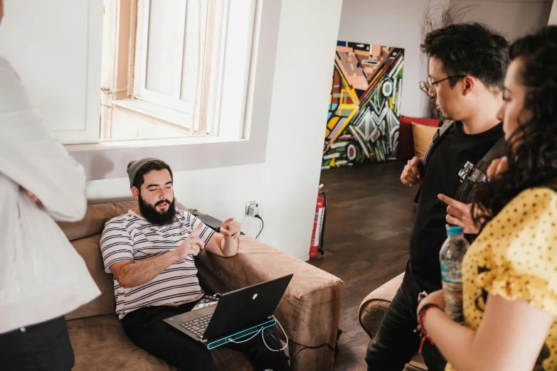 a man sitting on the floor with a laptop