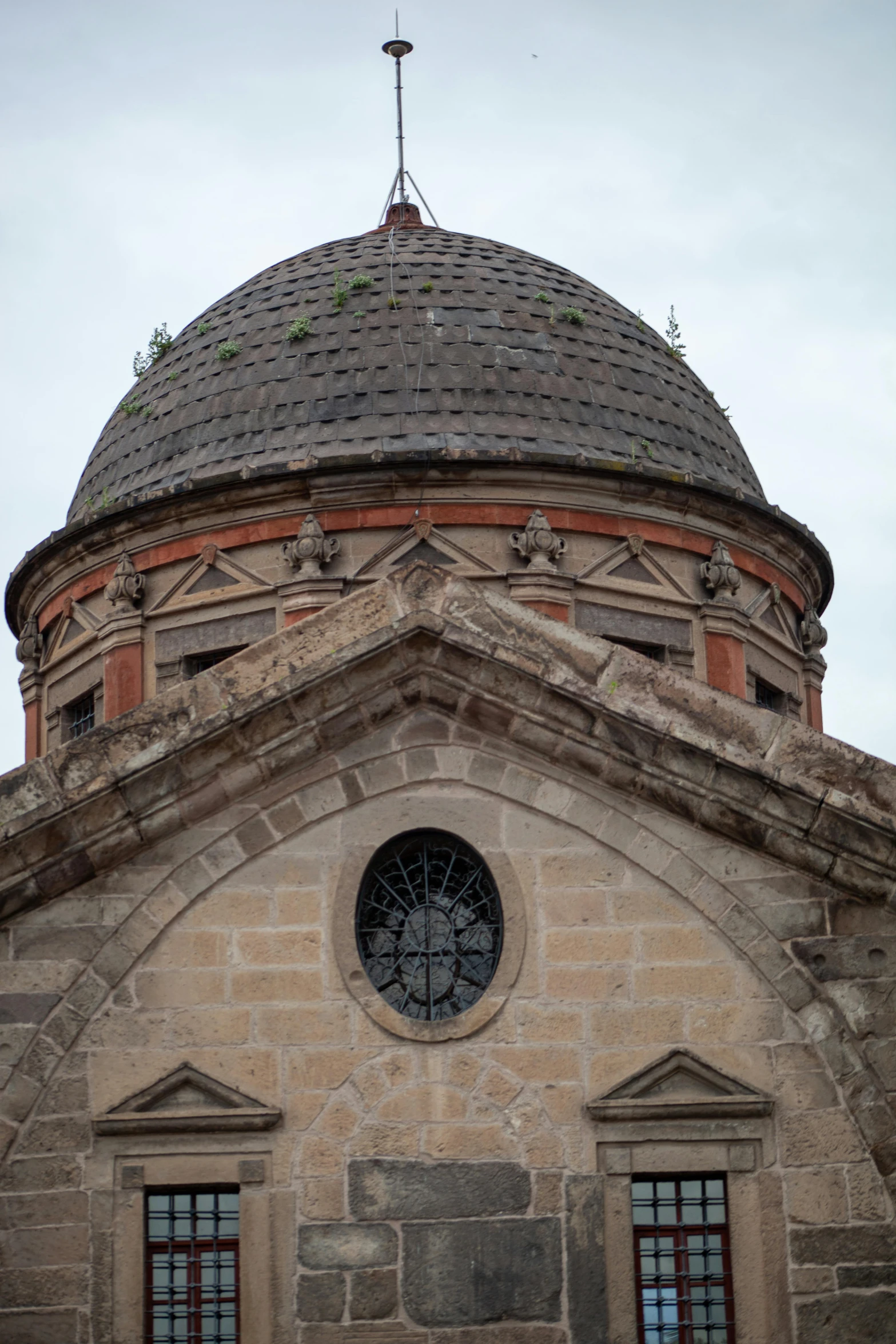 large, old brick building with a cross on top