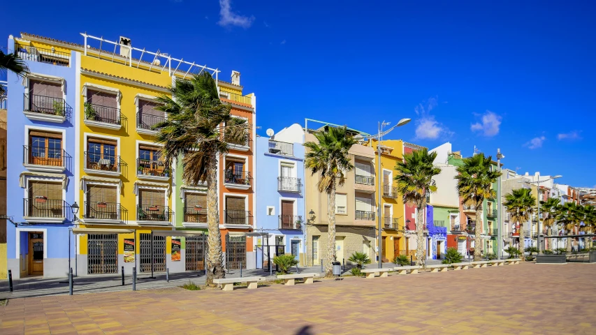 a row of multicolored buildings on the street