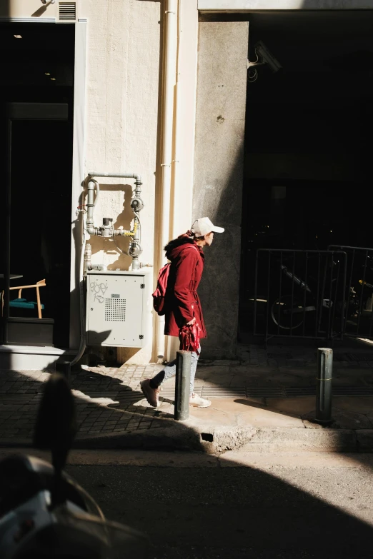 a person standing by an atm machine in the street