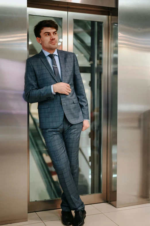 a man standing by an elevator door