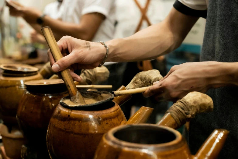 a man playing an instrument while others play musical instruments