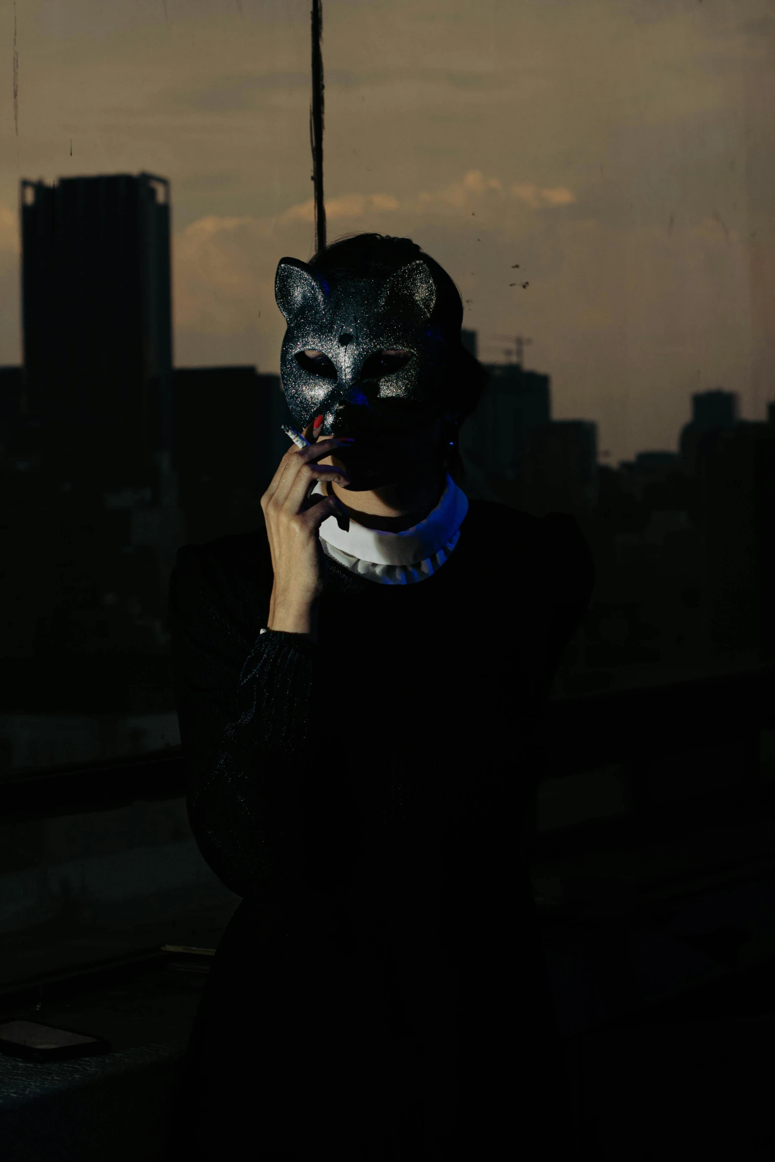 a person wearing a mask and talking on a cellphone