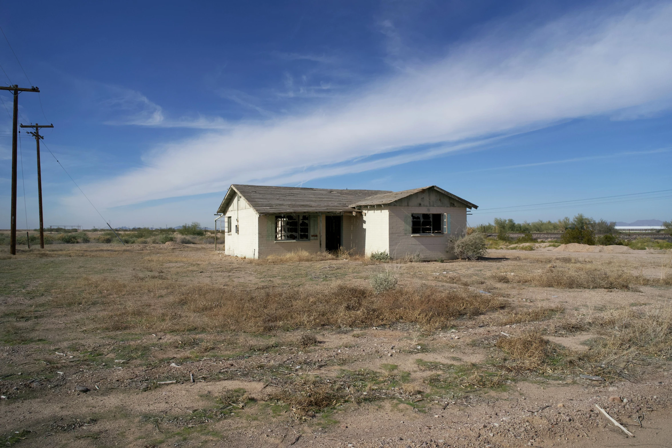 this abandoned house sits in an open field