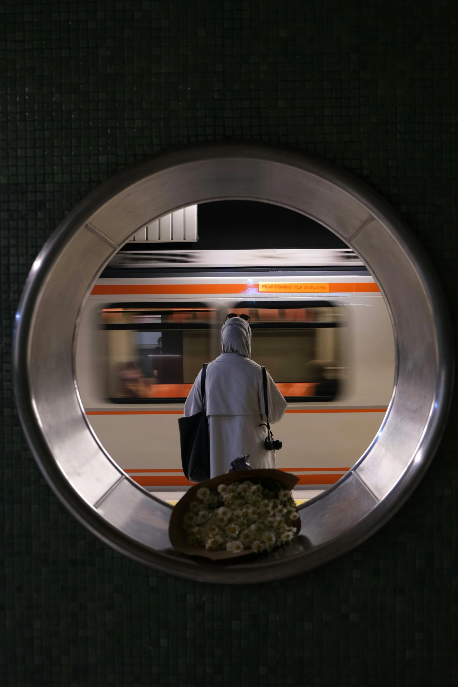 a man walking towards the subway car with luggage