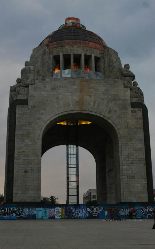 a cement arch with graffiti on the walls