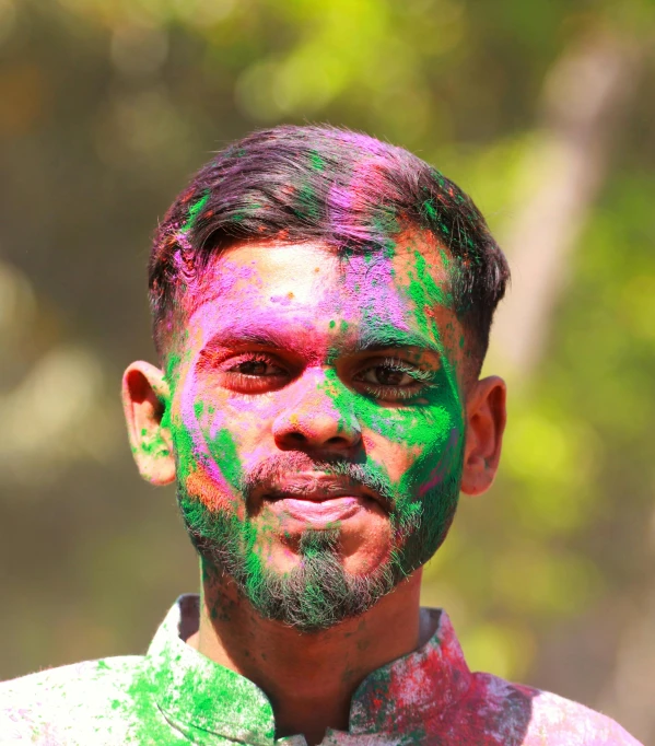 a man has lots of colors all over his face