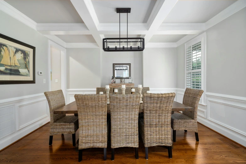 the large dining room has a wooden table and chairs