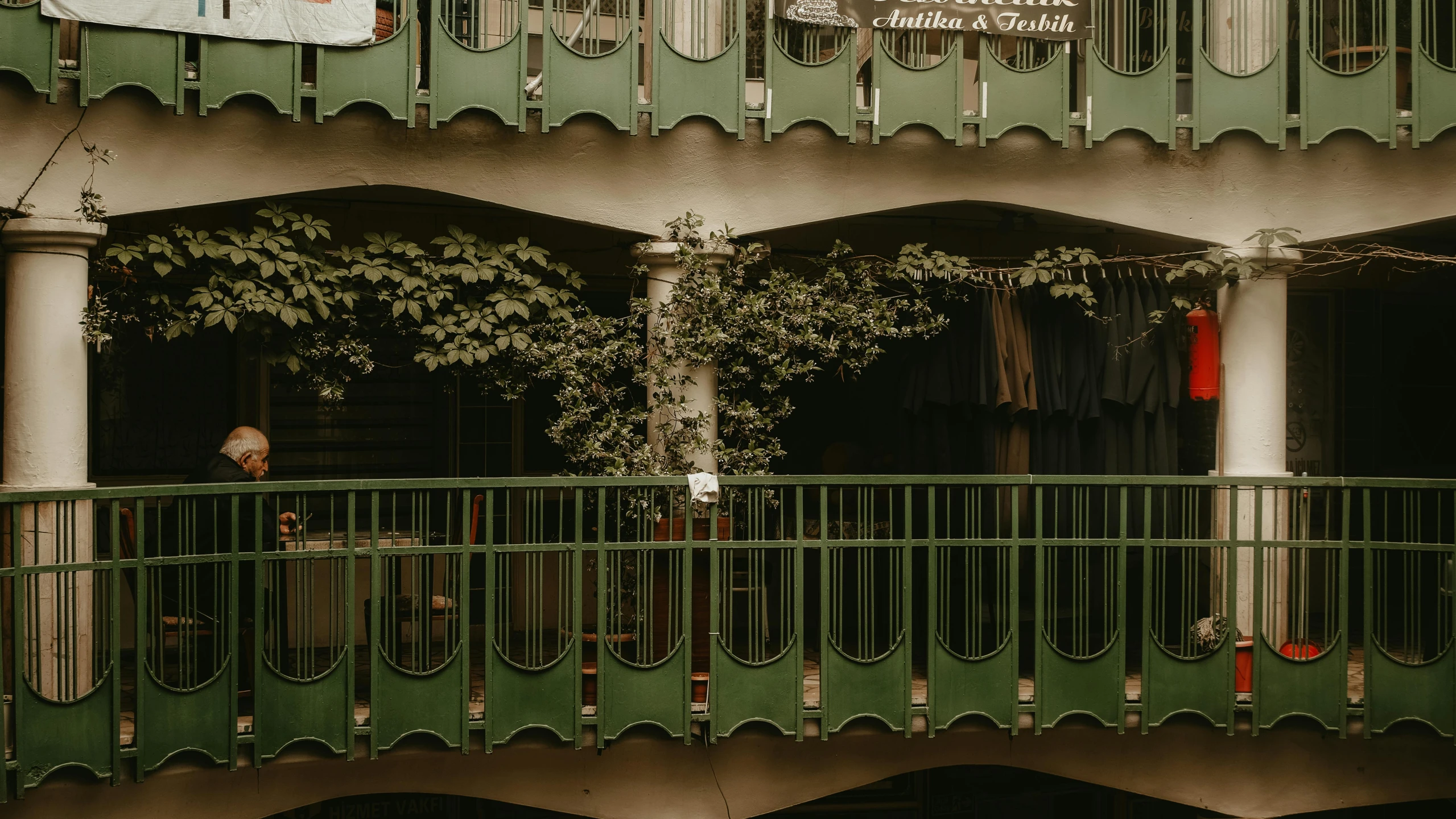 green building with balconies on balcony and a balcony between windows