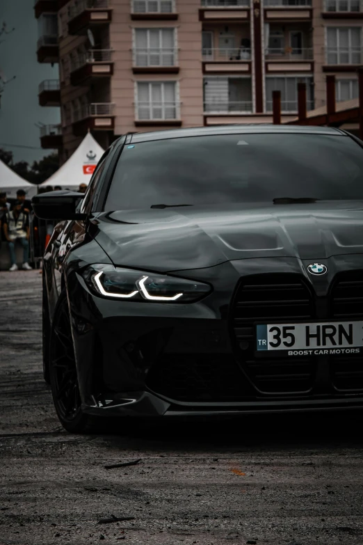 a modern, black bmw is parked on the street