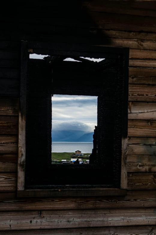 a man is standing outside his cabin window