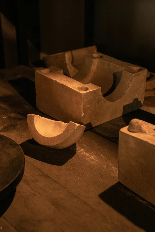 three wooden bowls sitting on top of a stone slab