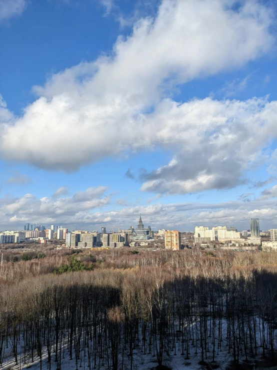 a beautiful view of a city across the valley, in winter