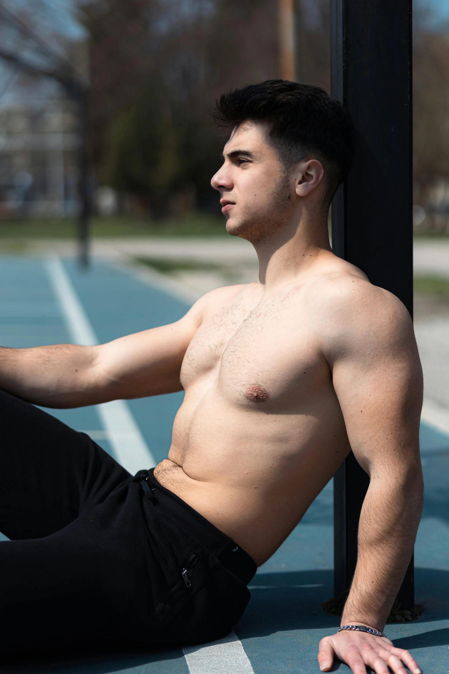 a man is sitting on the floor in the tennis court