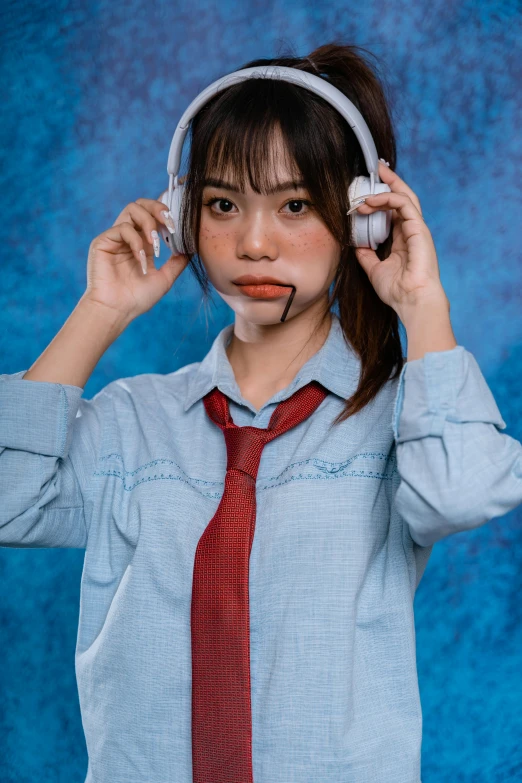 a person with a tie and headphones near her ear