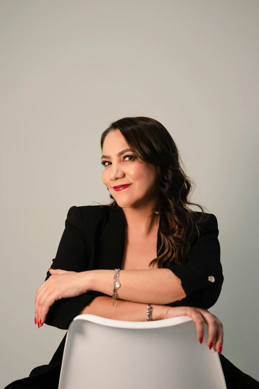 woman sitting down in a chair smiling at the camera