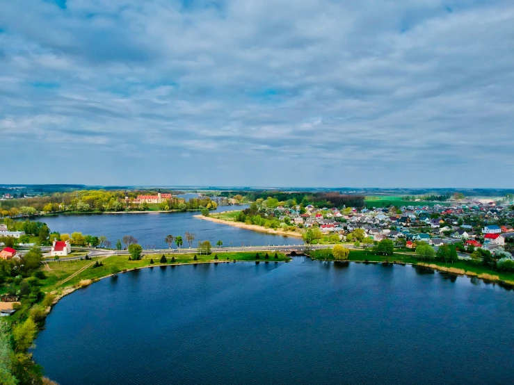 a body of water surrounded by trees and a small town