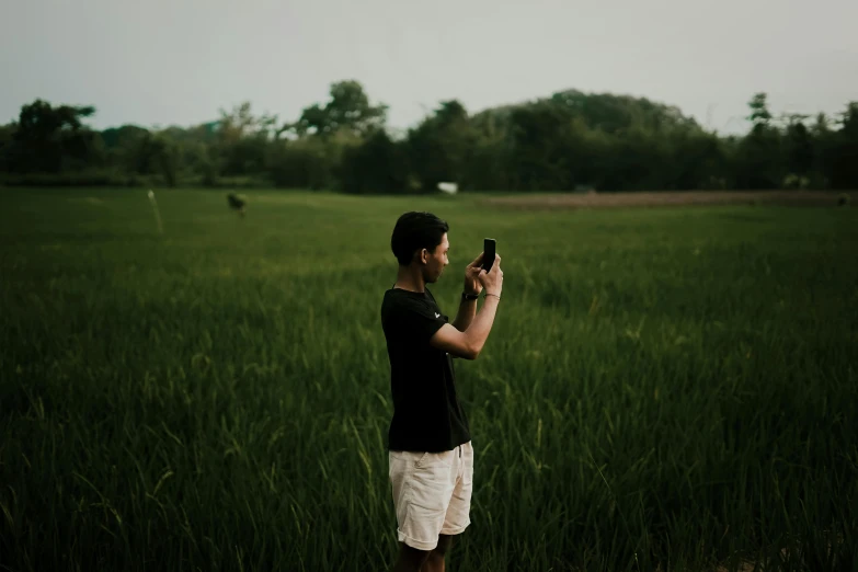 a man taking a picture of an open field