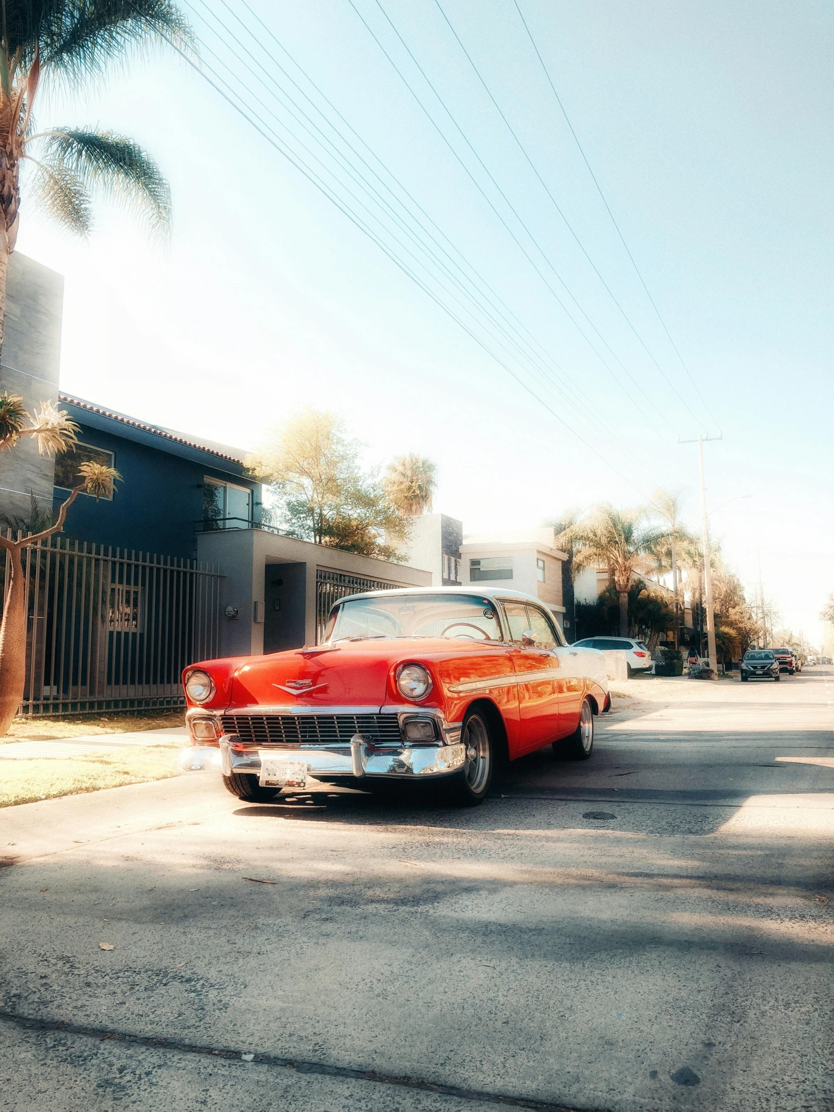 an old classic car parked in a driveway