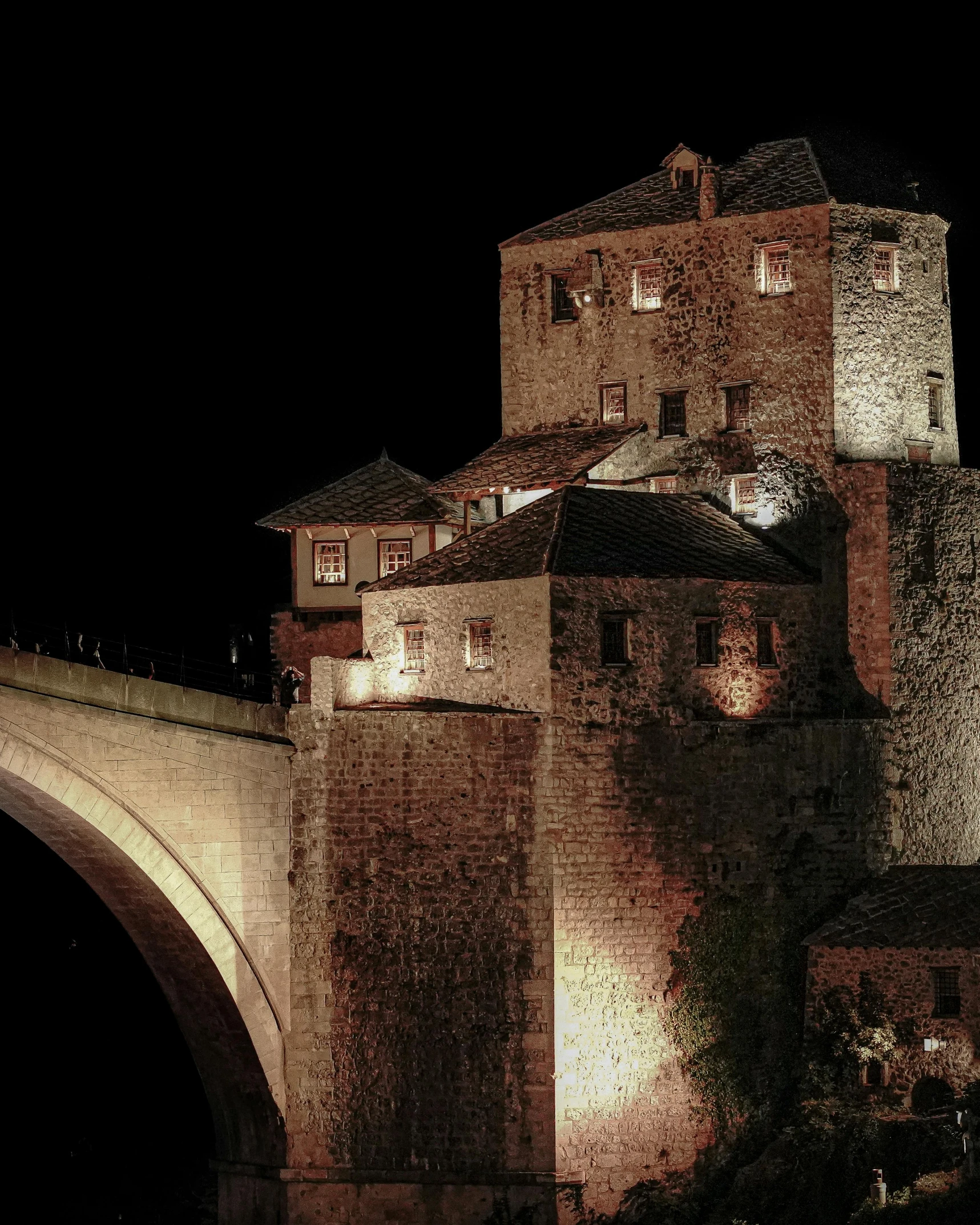 an old stone building is lit up by lights