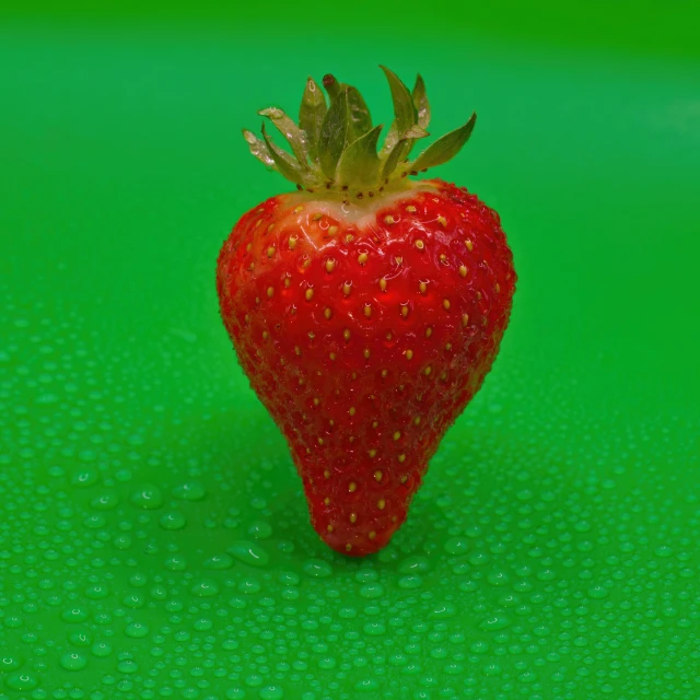 a red strawberry with some sort of stem sticking out