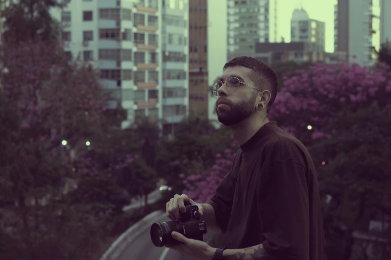 a man with a beard holding a camera