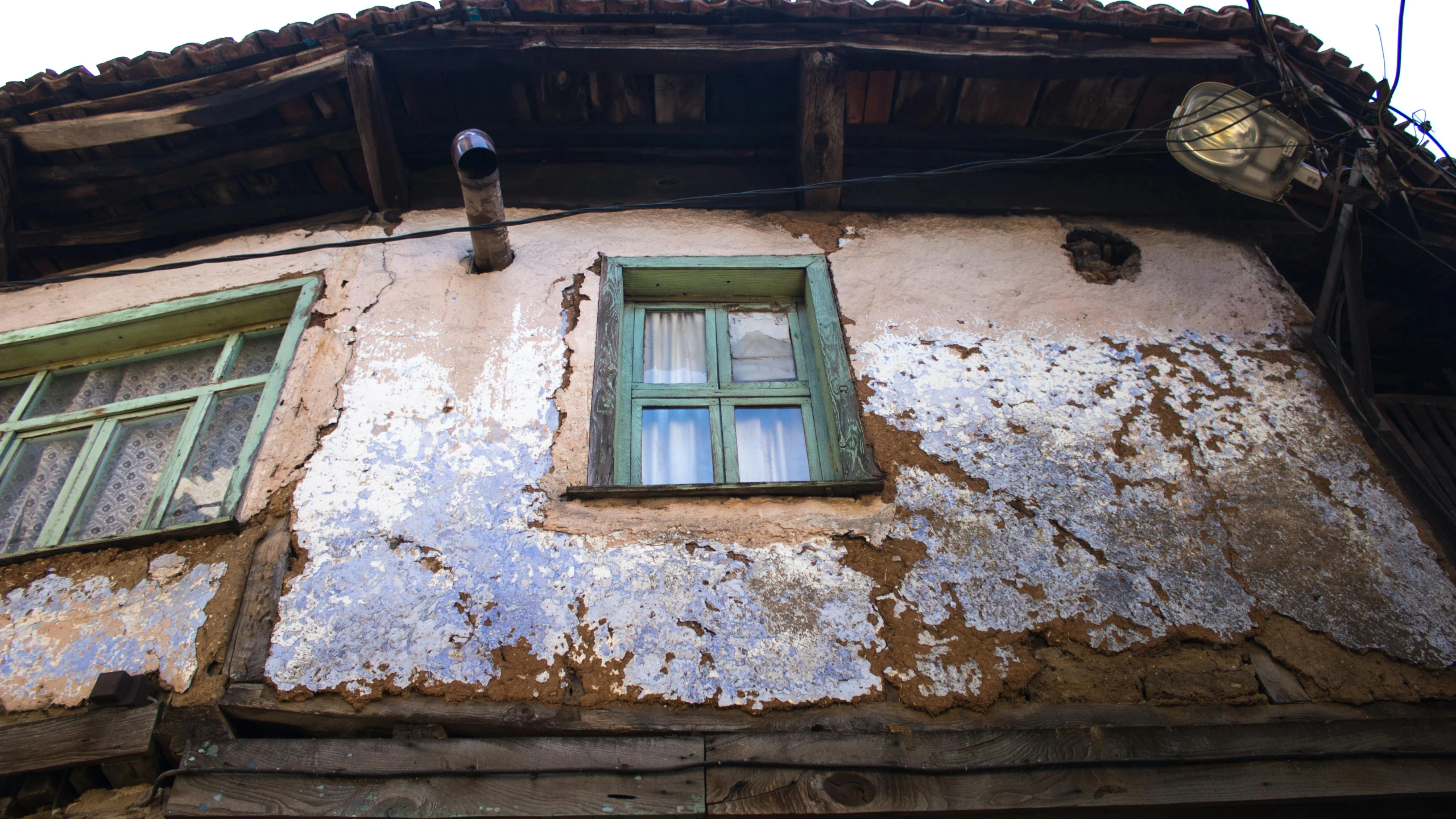 the old building has windows with shutters open