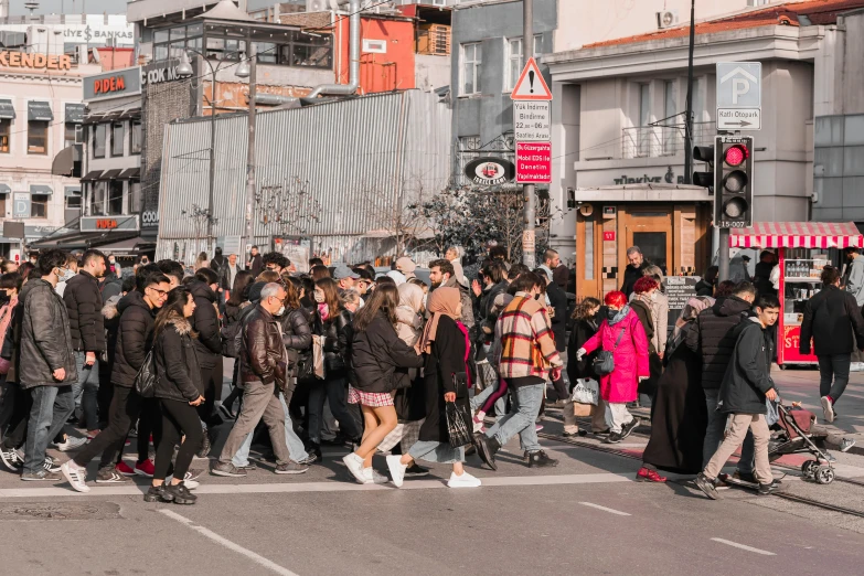 a bunch of people that are walking across the street