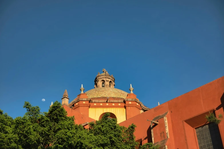 a tall red building with a sky background