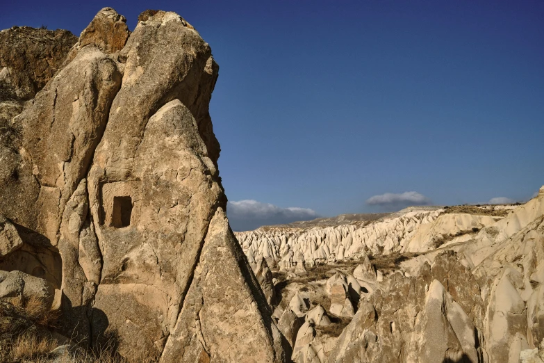 a rocky landscape is shown under a blue sky