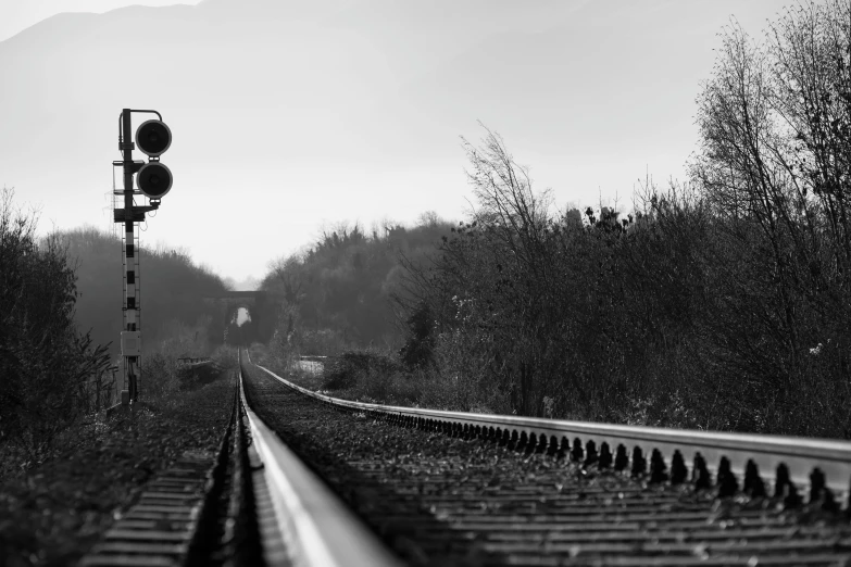 a black and white pograph of an empty train track