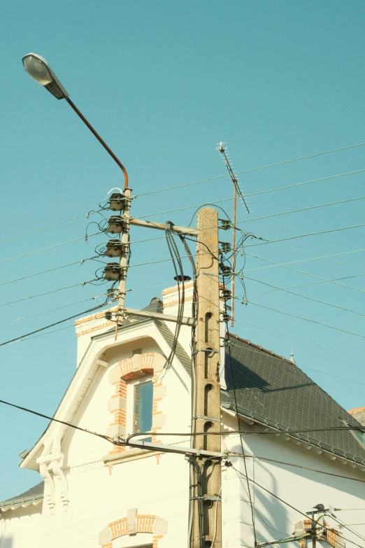 several electrical lines hang over an old building