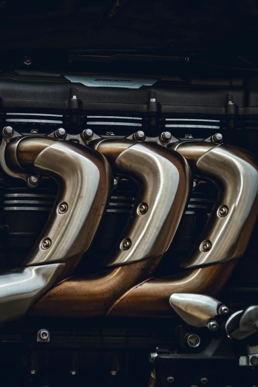 four polished metal and wood handles on the door handle of an old fashioned car