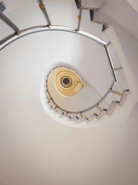 looking down on an unusual spiral staircase with ss handrails