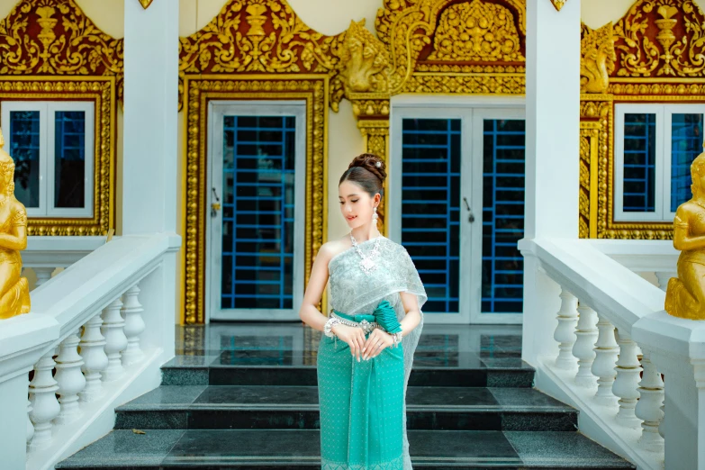 a woman standing in front of some very fancy doors