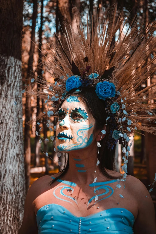 a woman with a large feather hat and painted body paint