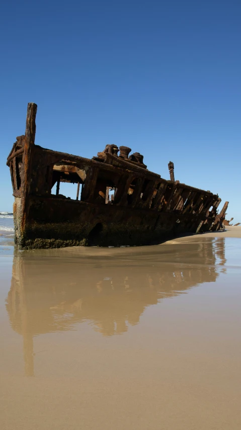 an old ship on the beach in the sand