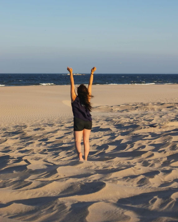 a woman in a black shirt on the beach