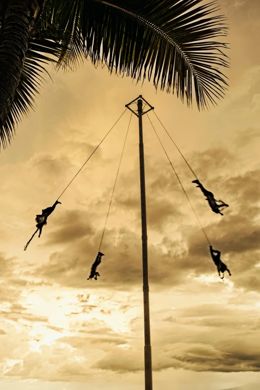 silhouettes of people on a mast are in the background