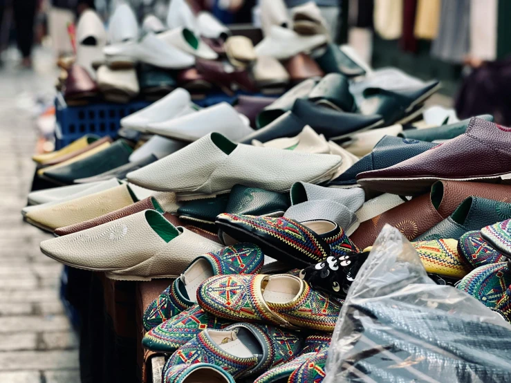 rows of shoes sitting on a market stand