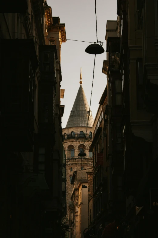 a clock tower in the distance with some buildings around