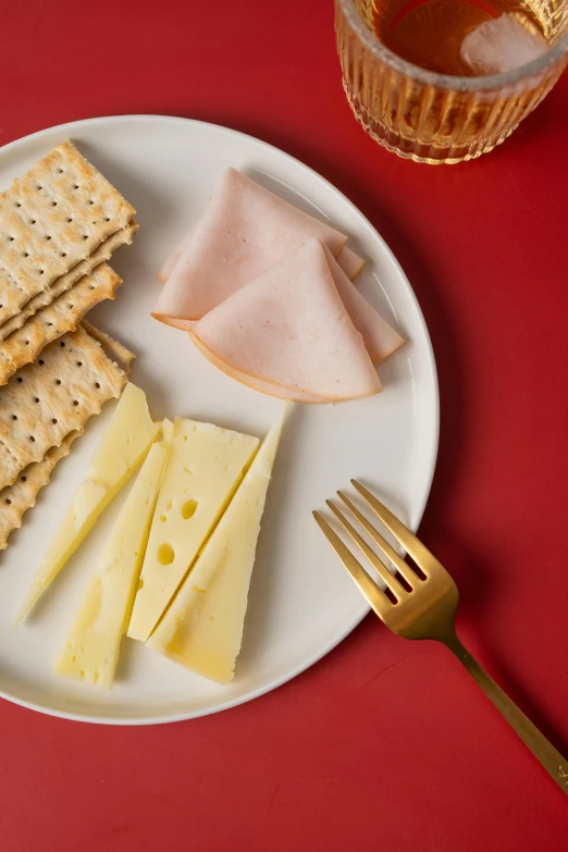 a white plate topped with ers next to two cups and a fork