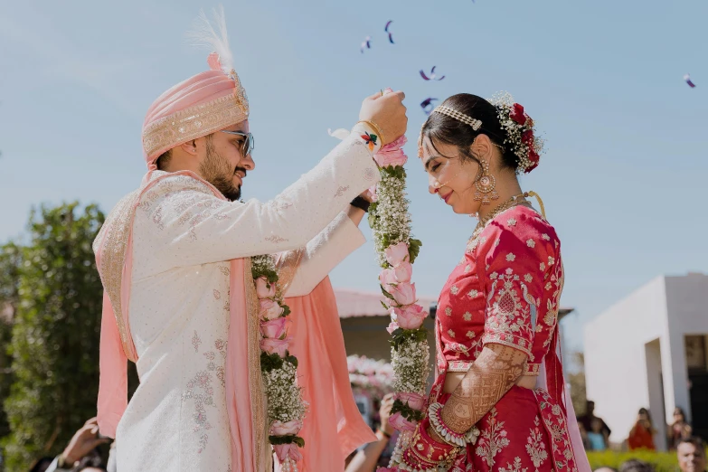 a man holding onto his hand near the other woman in pink