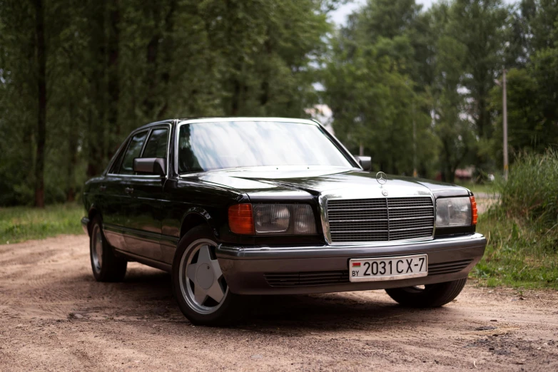 a mercedes 240 sel wagon is parked in the dirt