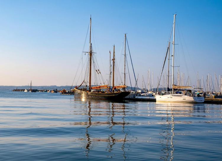 a line of ships in the harbor waiting for passengers