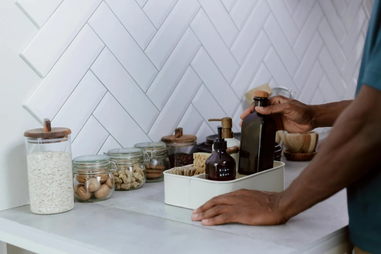 a man is putting the ingredients into his container