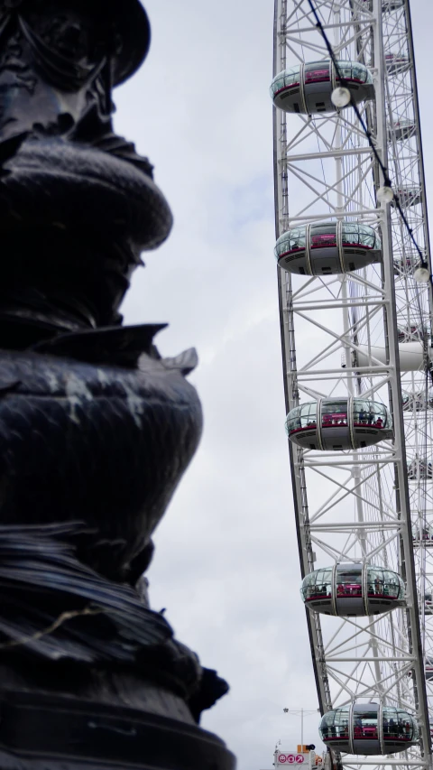 a large ferris wheel sitting next to a tall ferris wheel