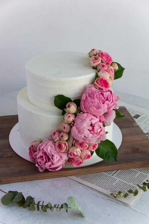 a large white cake with pink flowers on top